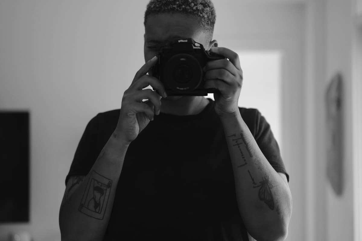 Kayla shooting a mirror self-portrait with the caged S5IIX