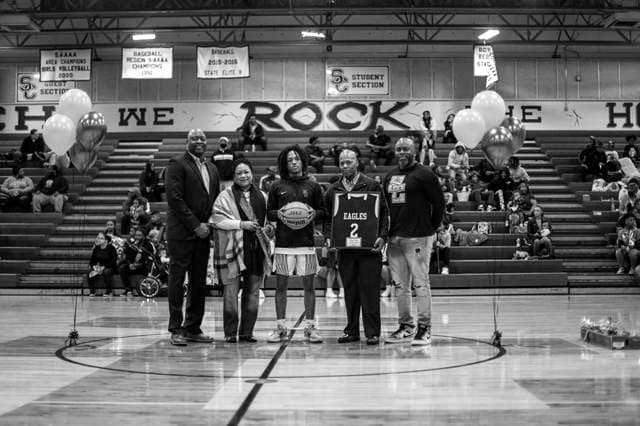 Senior Night ceremony with family at center court