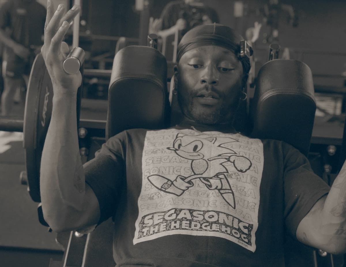 Fife at the top of a shoulder press, both arms locked out