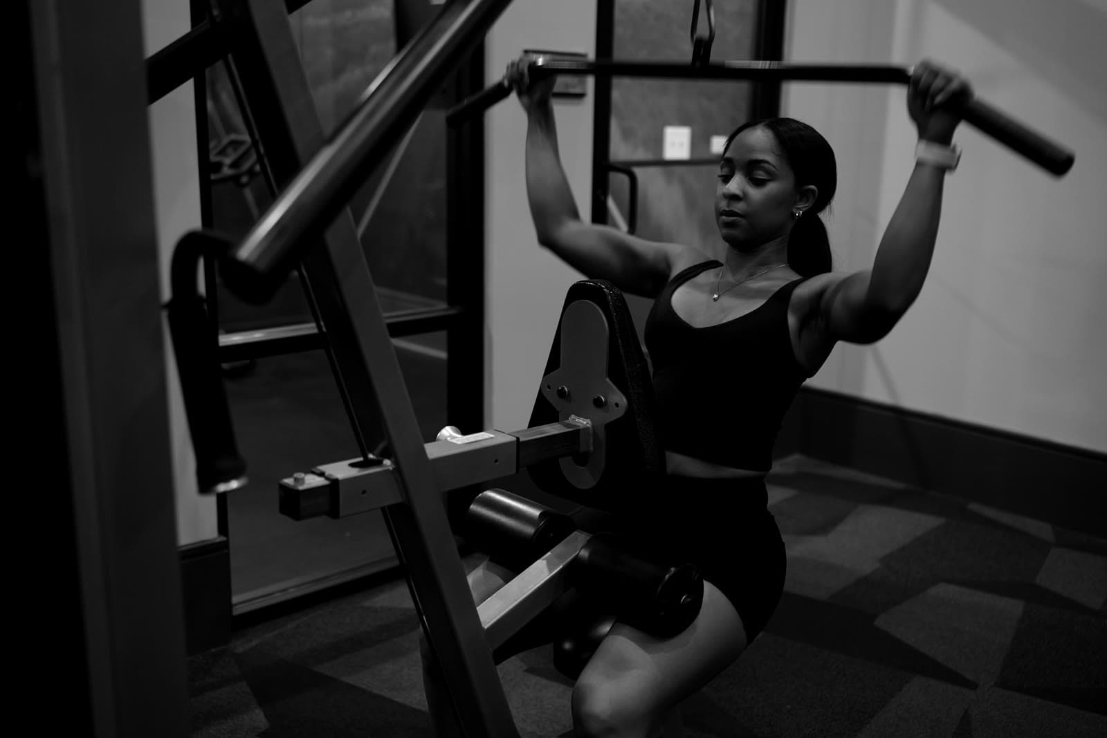 Athlete pressing on a cable machine