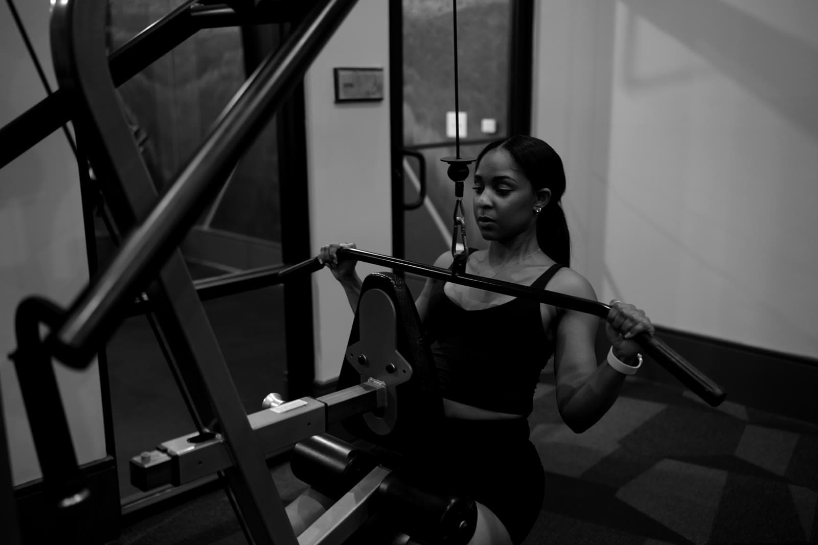 Athlete on a cable machine, arms raised